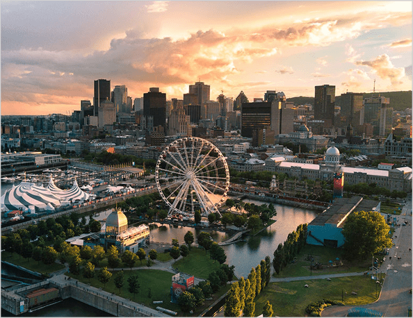 Montreal skyline with view of park with ferris wheel and skyscrapers in the background.