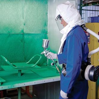 Spray painting wearing full protective clothing and mask.